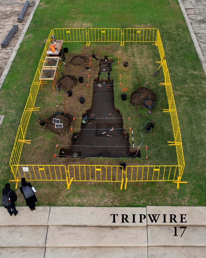Front cover of TRIPWIRE 17, featuring the journal name and number in the bottom right corner and a cover image which is a photo by Nicholas Galanin, “Shadow on the land, an excavation and bush burial,”
earthworks, archaeological dig tools, barriers, 2020.
